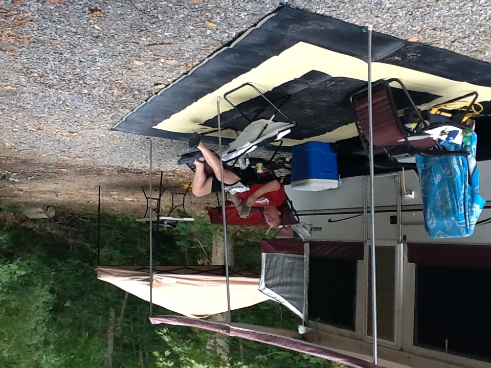 The Binker Lee 1999 Jayco Eagle popup camper set up at a wooded family campsite