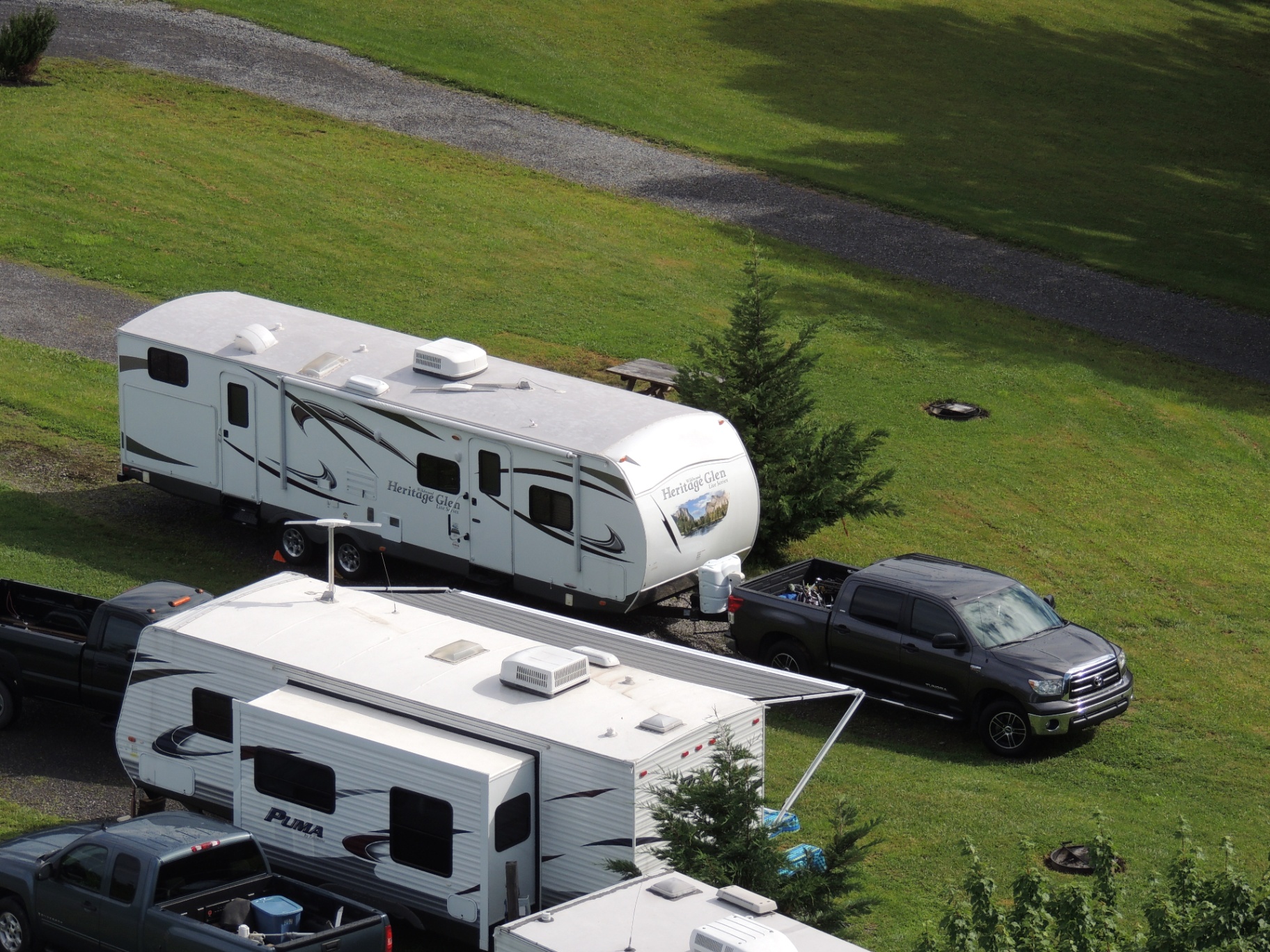 Aerial view of the 2013 Heritage Glen 312QBUD parked at a campground with slide-outs extended