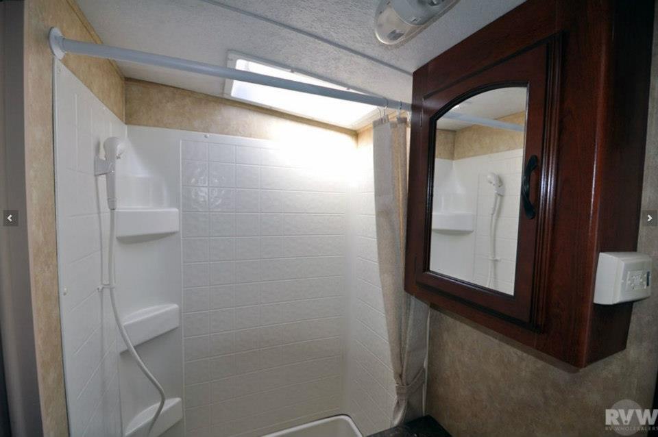 Heritage Glen bathroom shower stall with built-in shelves and wood medicine cabinet