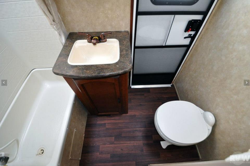 Overhead view of the Heritage Glen 312QBUD bathroom with porcelain toilet, vanity sink, and tub