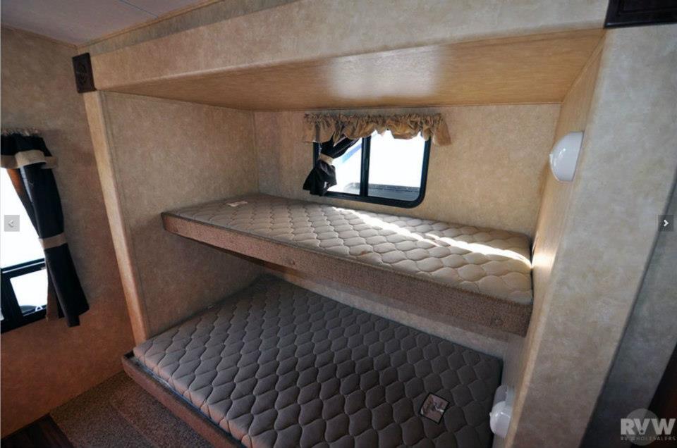 Rear bunkhouse of the Heritage Glen 312QBUD with double over double bunk beds and window