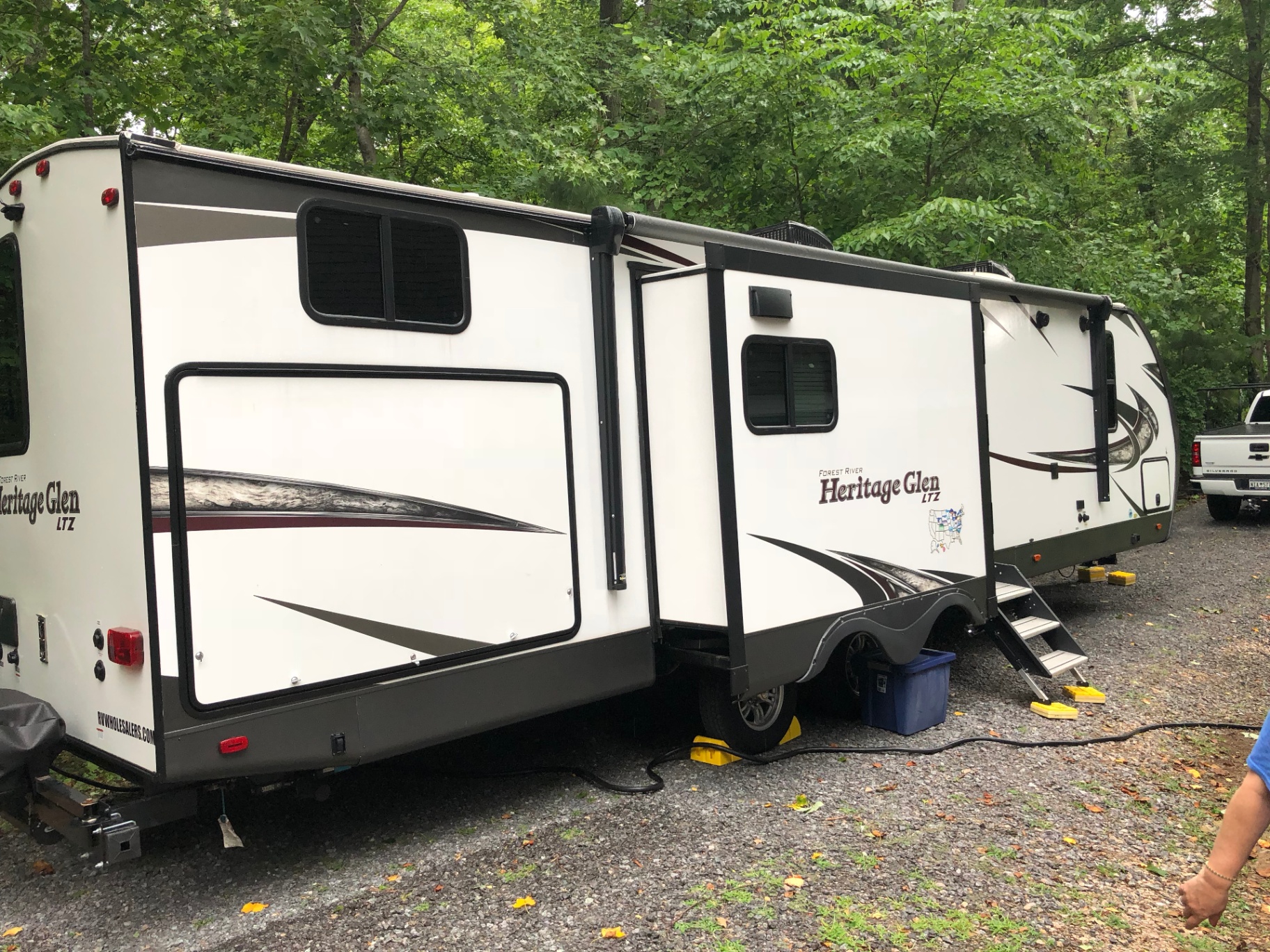 Heritage Glen LTZ 312QBUD at a wooded campsite with both slide-outs extended