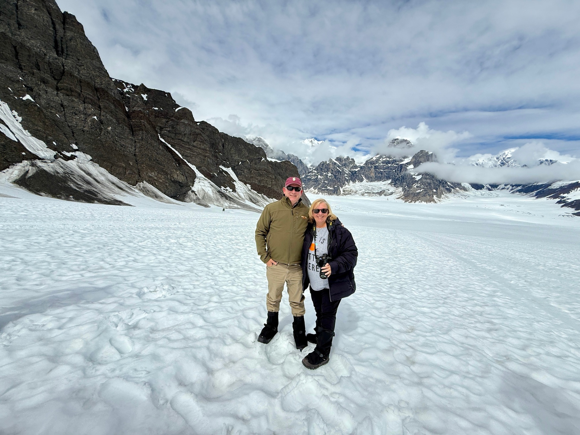 Chad and Donna standing together on a glacier during a Denali flightseeing trip