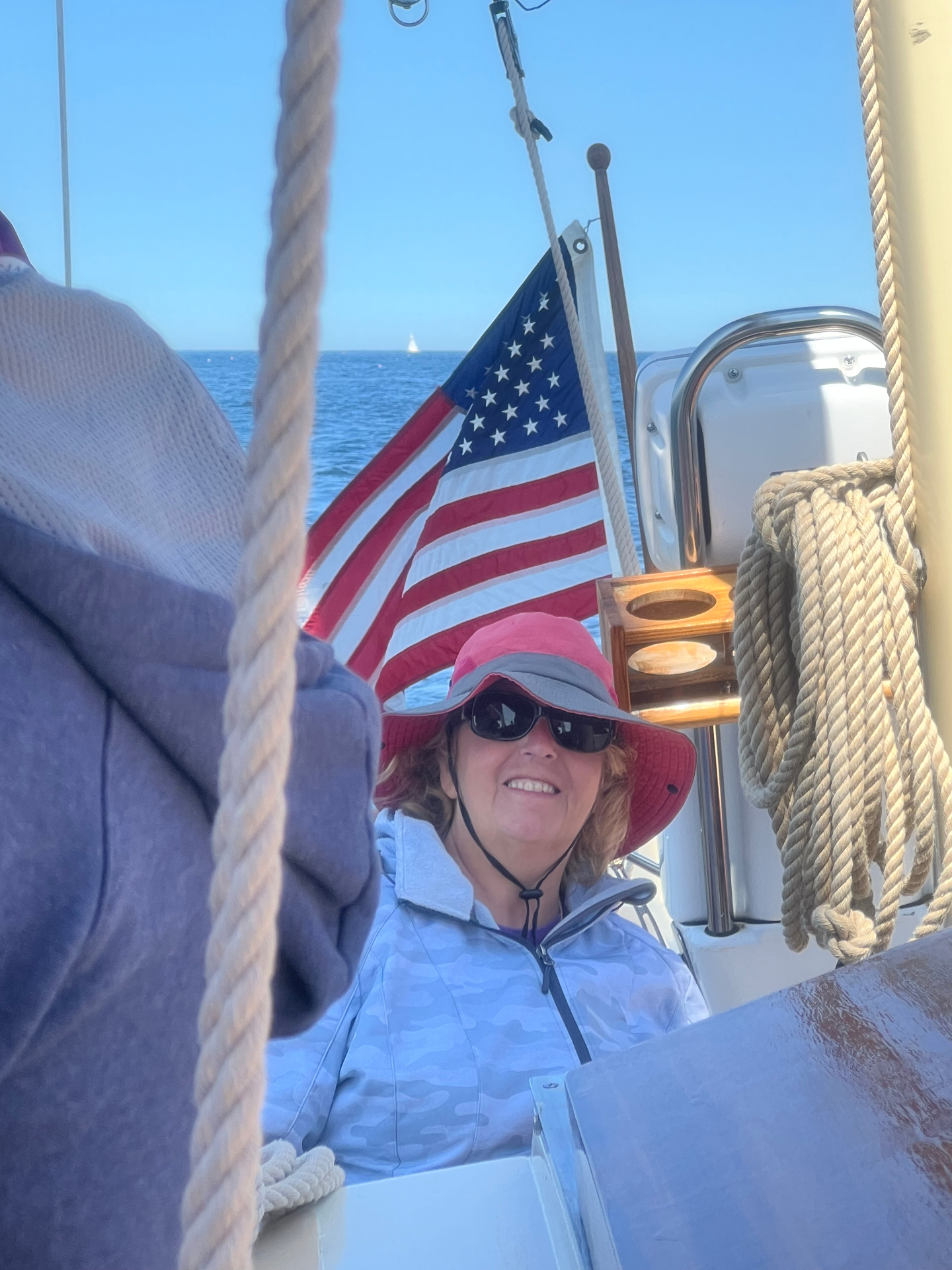 Donna smiling aboard a sailboat in Kennebunkport