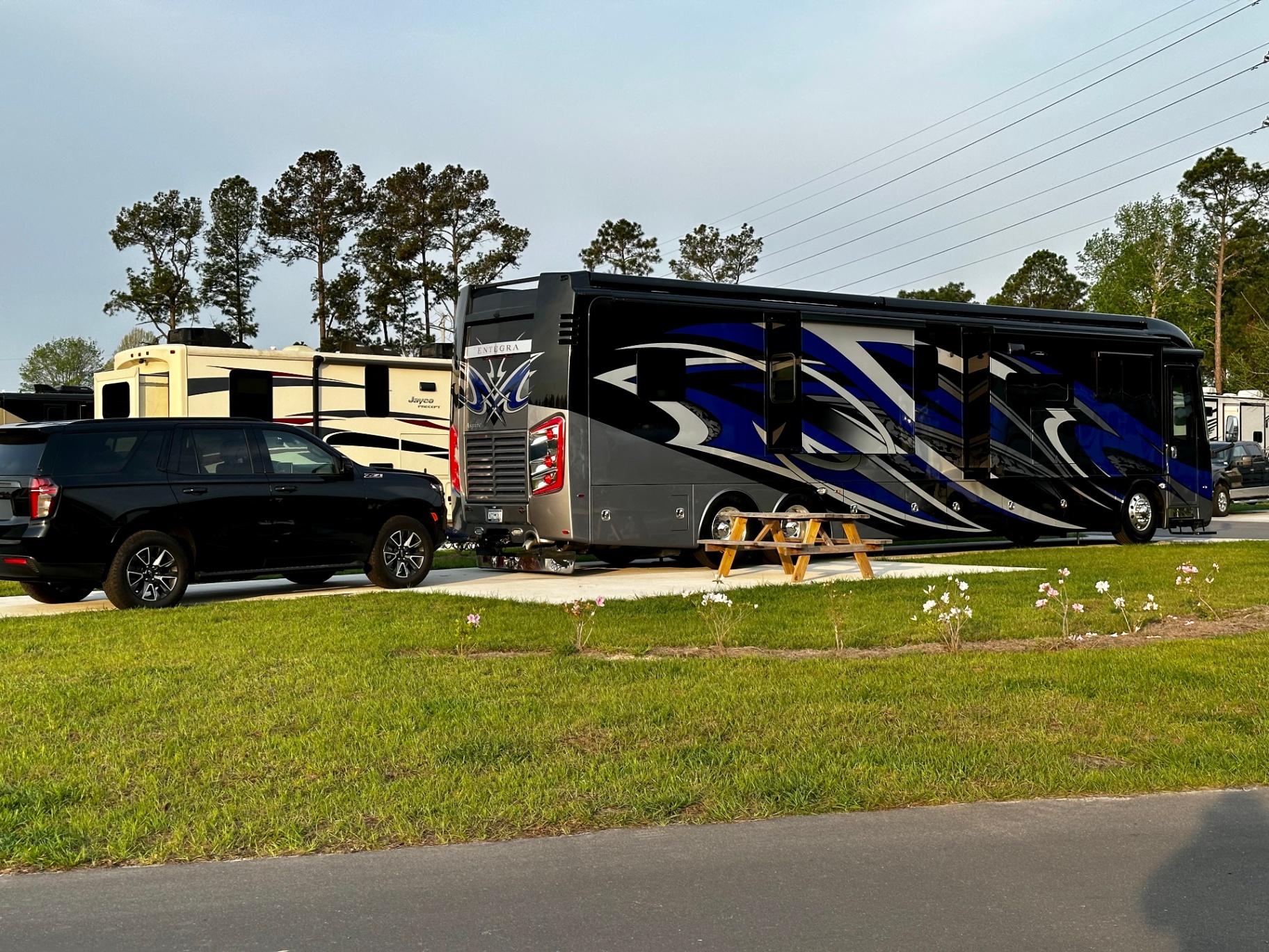 2021 Entegra Aspire 44W parked at CreekFire RV Resort in Savannah, Georgia with a black SUV beside it