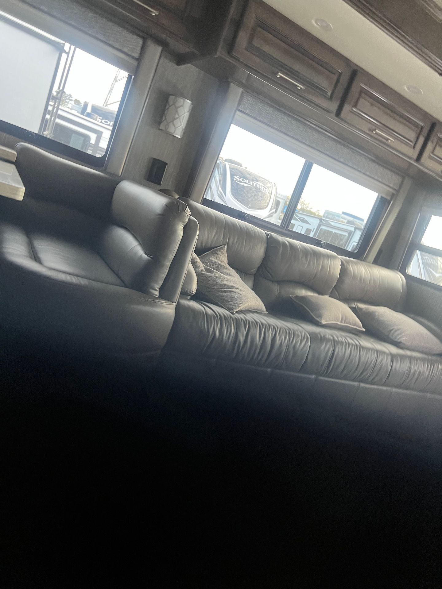 Leather sofa and window seating area inside the 2021 Entegra Aspire 44W