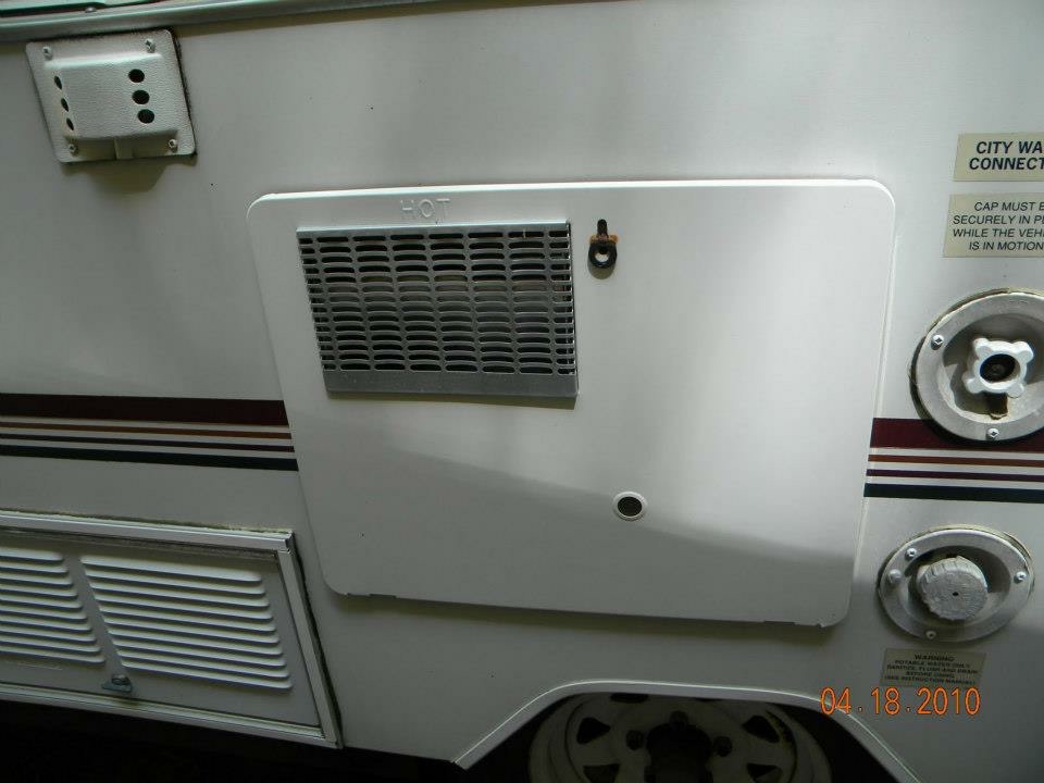 Exterior utility panel on the Jayco Eagle showing the city water inlet and shore power connection