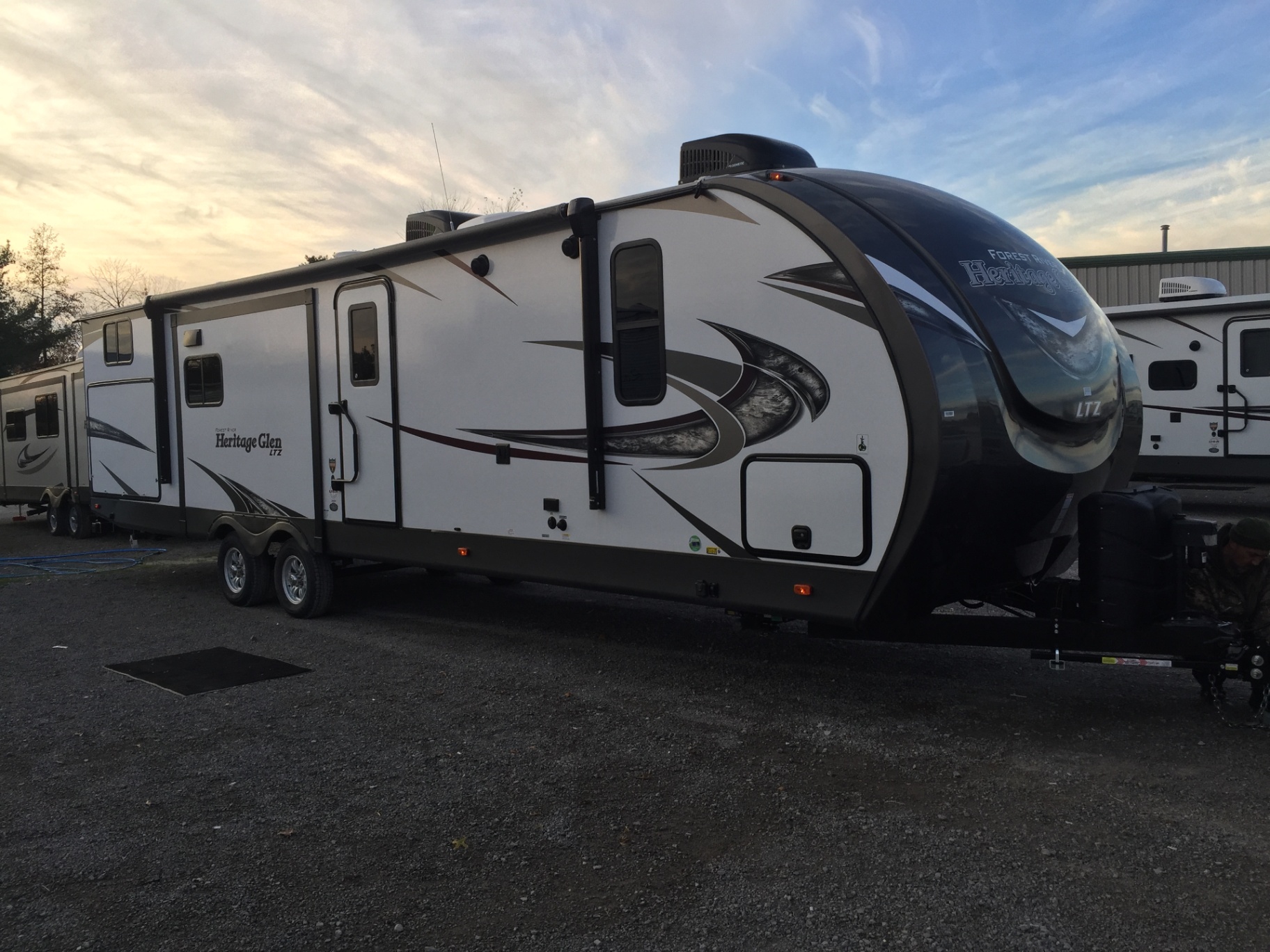 Driver-side exterior view of the 2018 Forest River Wildwood Heritage Glen LTZ 312QBUD on the dealer lot