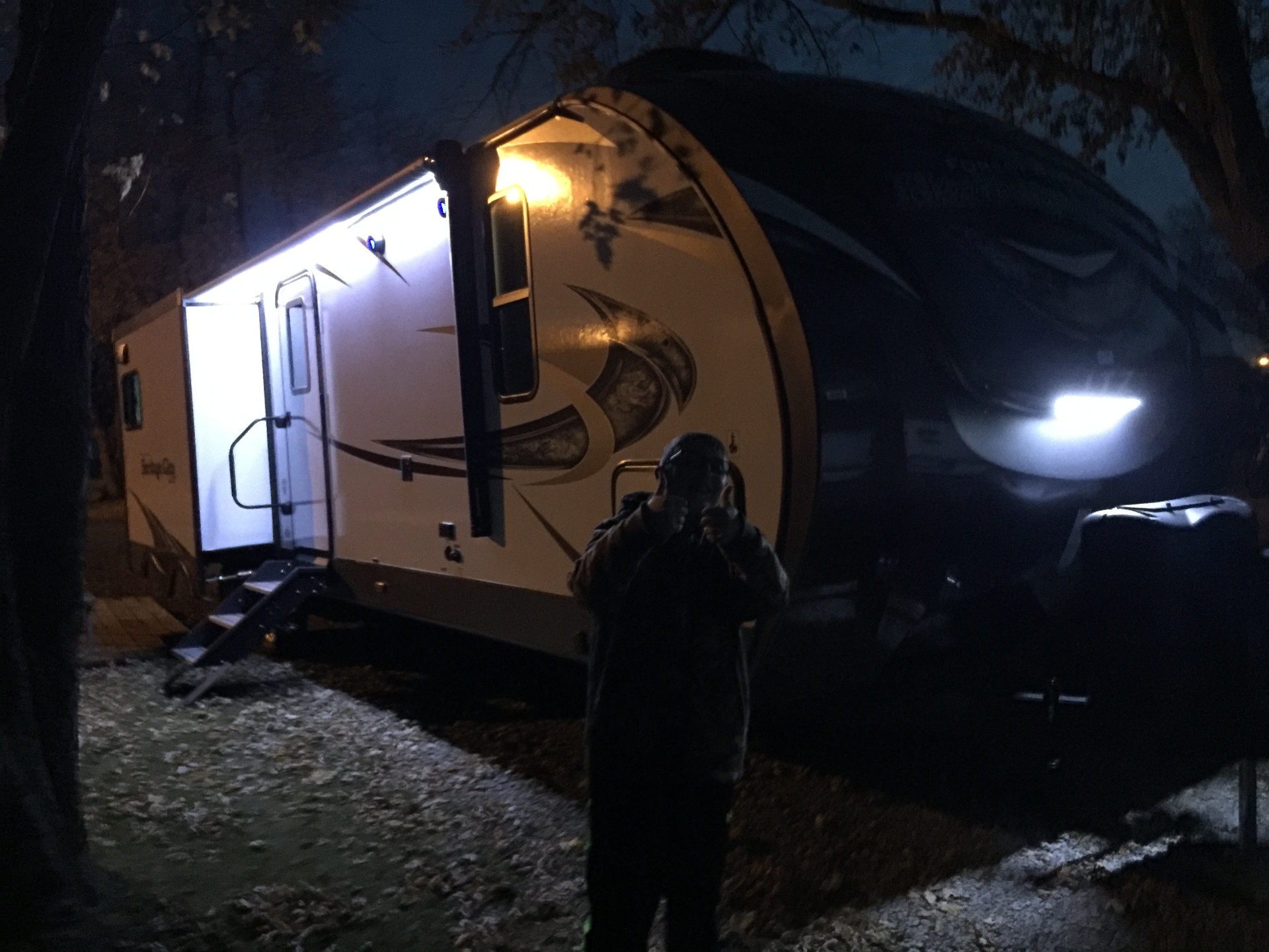 Heritage Glen LTZ at night with the entry door light glowing at the campsite