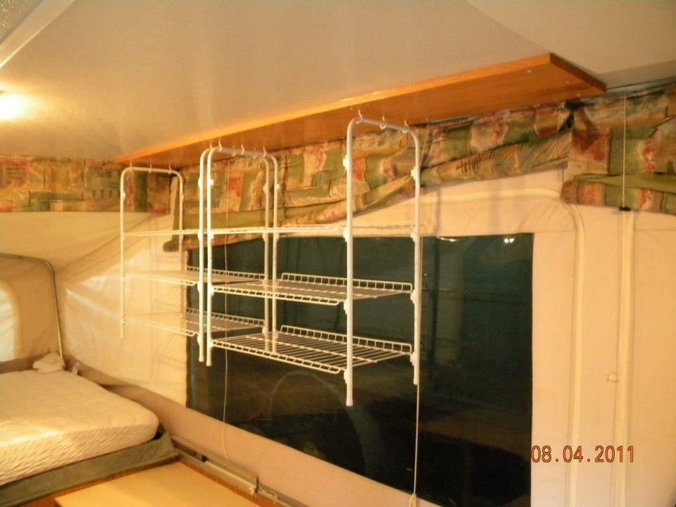 Wire shelving storage unit set up inside the Binker Lee popup camper