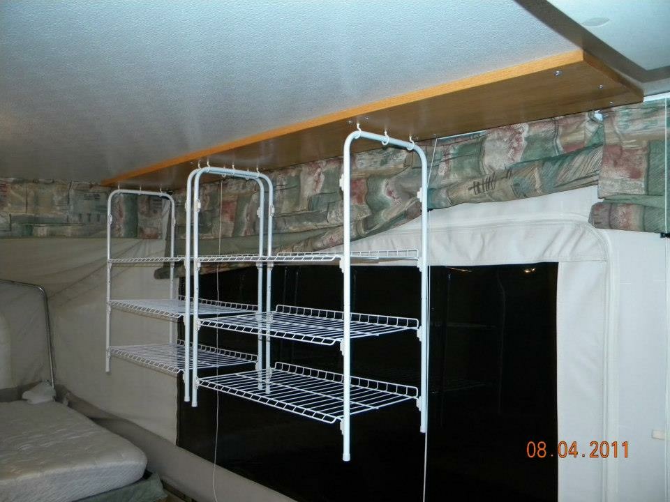 Additional storage shelves arranged along the canvas wall of the popup interior