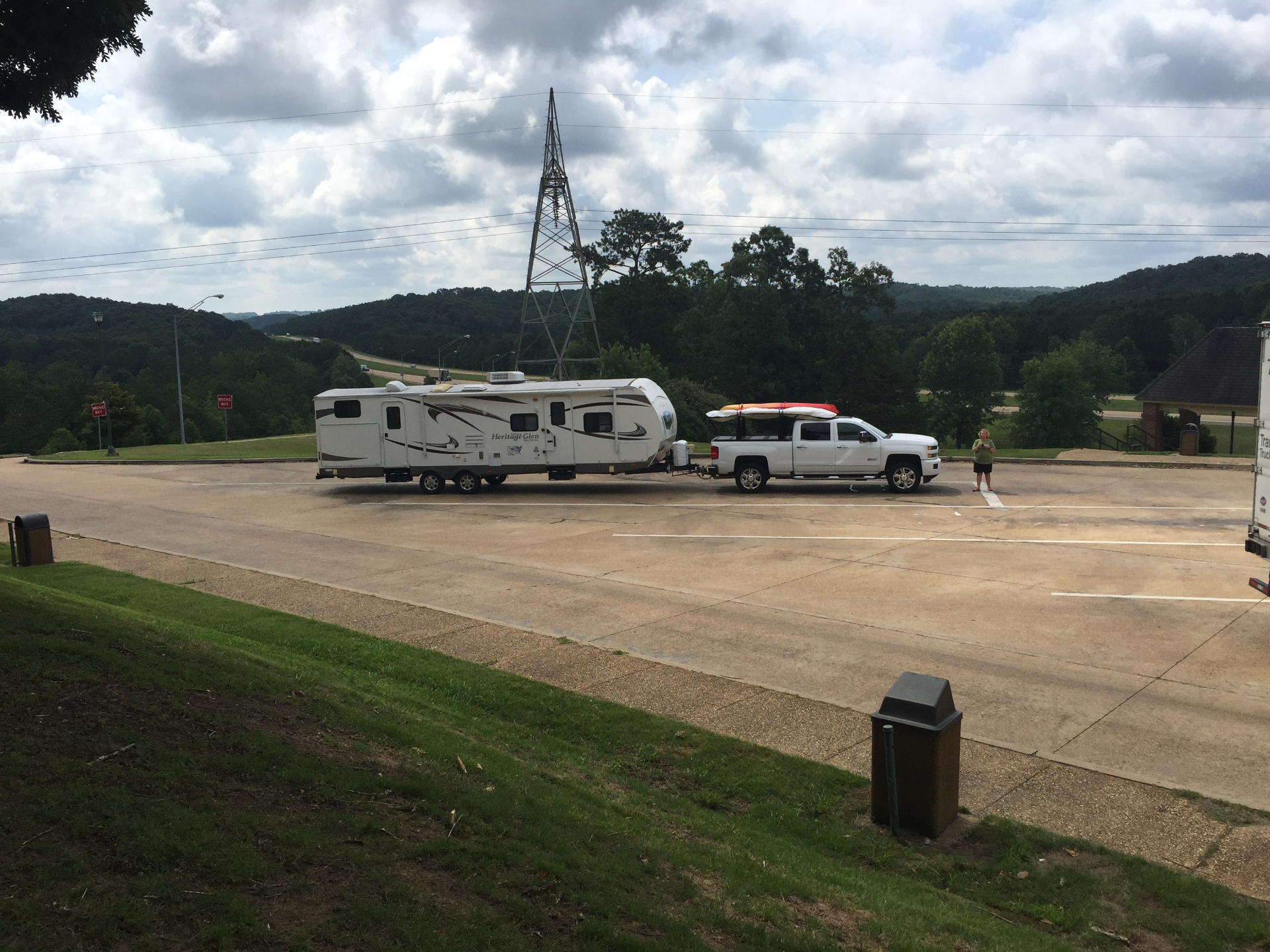Heritage Glen travel trailer and Silverado tow vehicle parked at a hilltop interstate rest stop