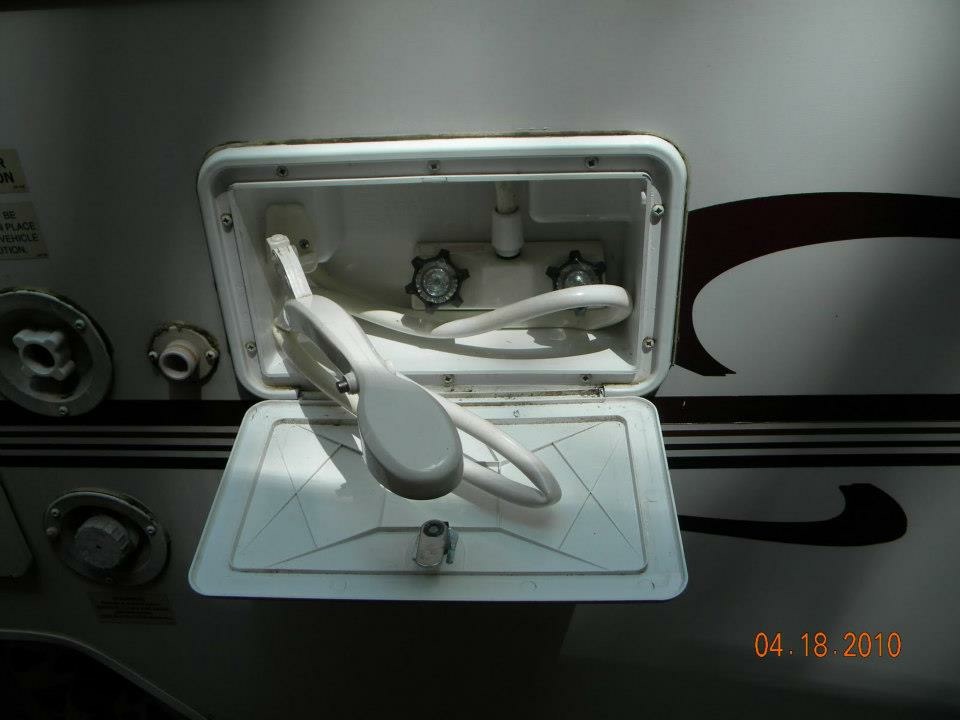 Open water hookup compartment with fresh-water fill and city-water inlet on the Binker Lee